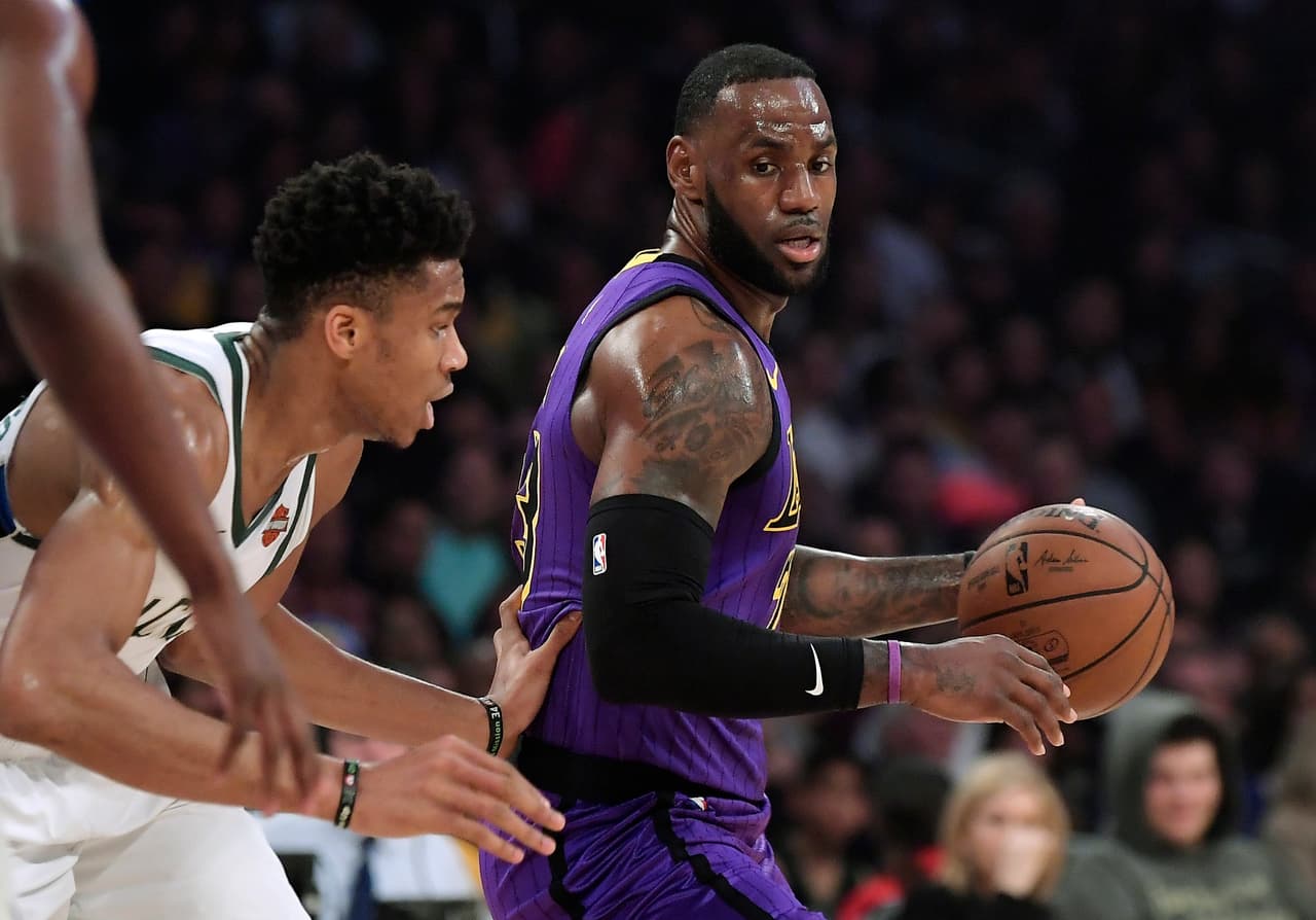 Los Angeles Lakers forward LeBron James, right, tries to move past Milwaukee Bucks forward Giannis Antetokounmpo during the first half of an NBA basketball game Friday, March 1, 2019, in Los Angeles. (AP Photo/Mark J. Terrill)