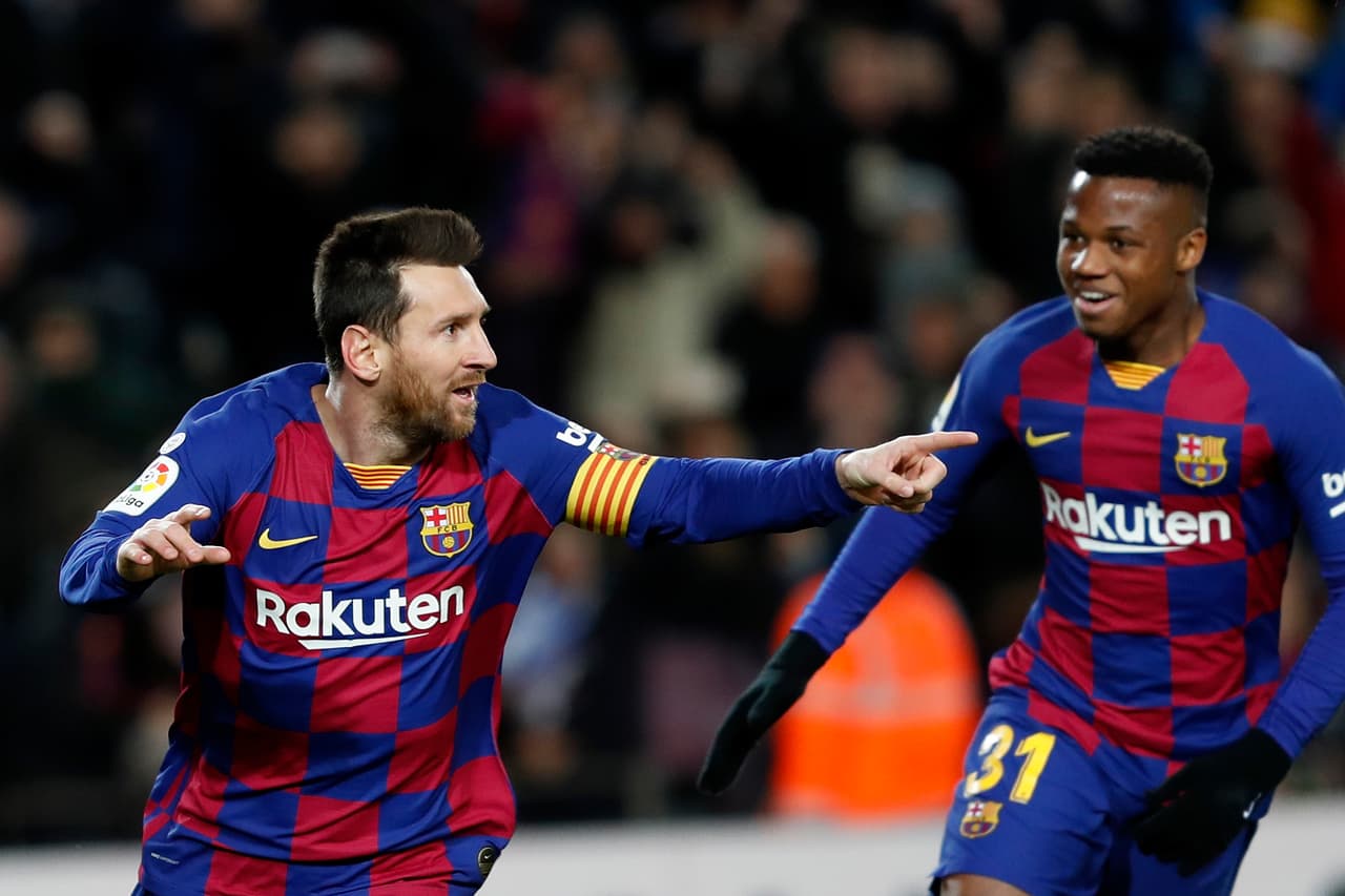 Barcelona's Lionel Messi, left, celebrates with Ansu Fati after scoring the opening goal during a Spanish La Liga soccer match between Barcelona and Granada at Camp Nou stadium in Barcelona, Spain, Sunday, Jan. 19, 2020. (AP Photo/Joan Monfort)