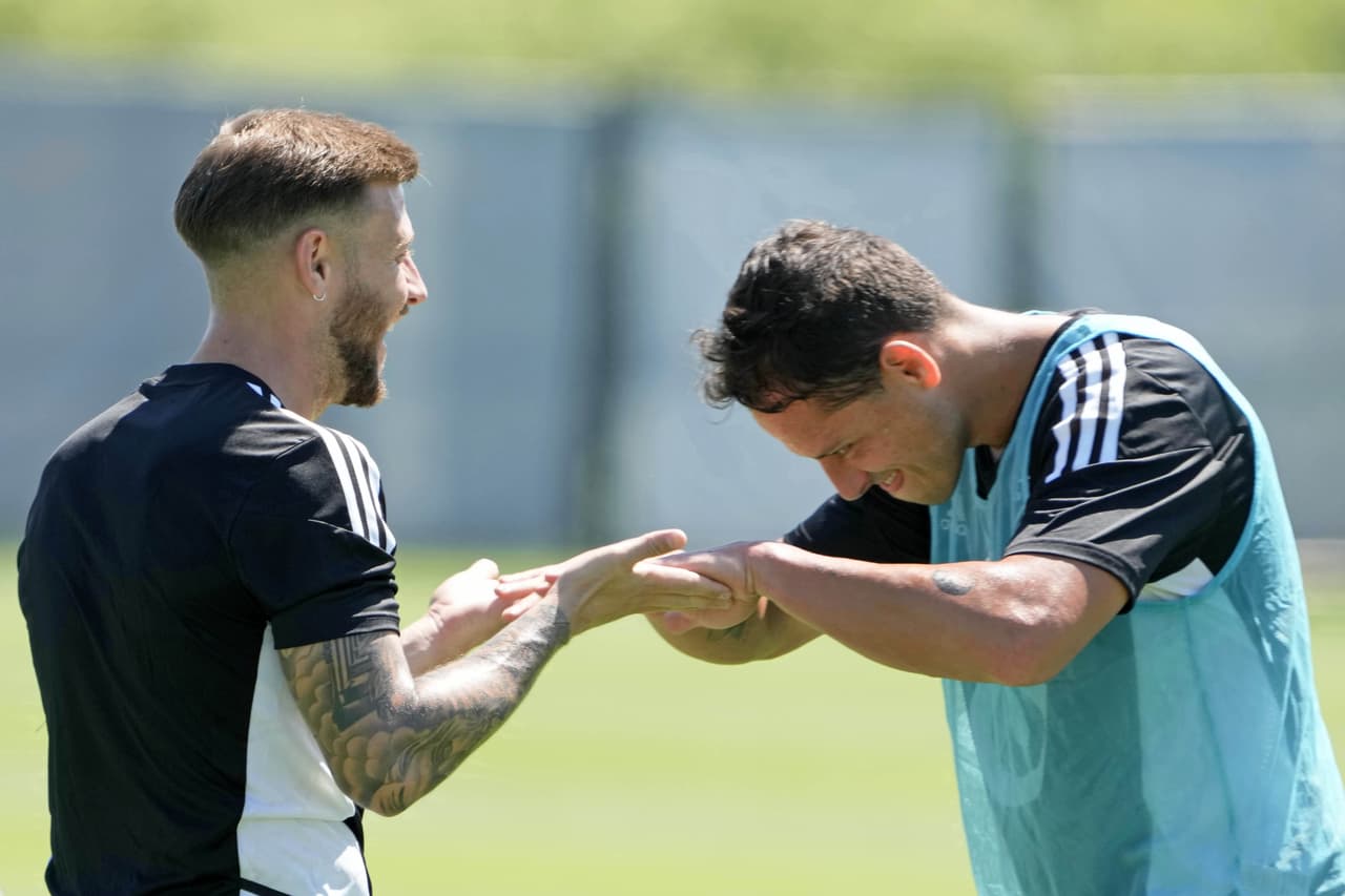 Aug 9, 2022; Blaine, MN, USA; MLS midfielder Paul Arriola (7) of FC Dallas (left) and forward Javier Hernandez (14) of LA Galaxy slap hands during a training session for the 2022 MLS All-Star Game at National Sports Center. Mandatory Credit: Kirby Lee-USA TODAY Sports