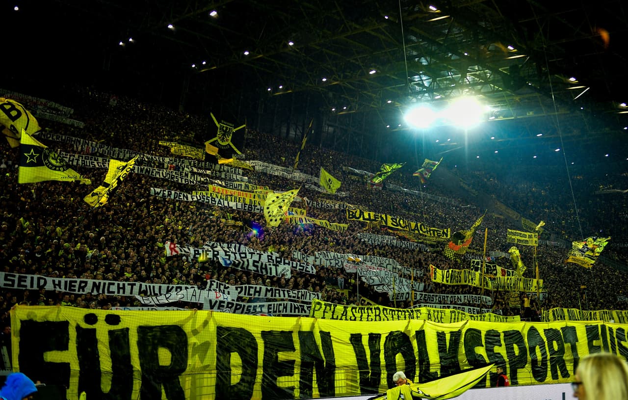 This picture taken on February 4, 2017 shows supporters of Dortmund displaying banners prior to the German First division Bundesliga football match between Borussia Dortmund and RB Leipzig, in Dortmund, western Germany. / AFP / SASCHA SCHUERMANN / RESTRICTIONS: DURING MATCH TIME: DFL RULES TO LIMIT THE ONLINE USAGE TO 15 PICTURES PER MATCH AND FORBID IMAGE SEQUENCES TO SIMULATE VIDEO. == RESTRICTED TO EDITORIAL USE == FOR FURTHER QUERIES PLEASE CONTACT DFL DIRECTLY AT + 49 69 650050 (Photo credit should read SASCHA SCHUERMANN/AFP/Getty Images)