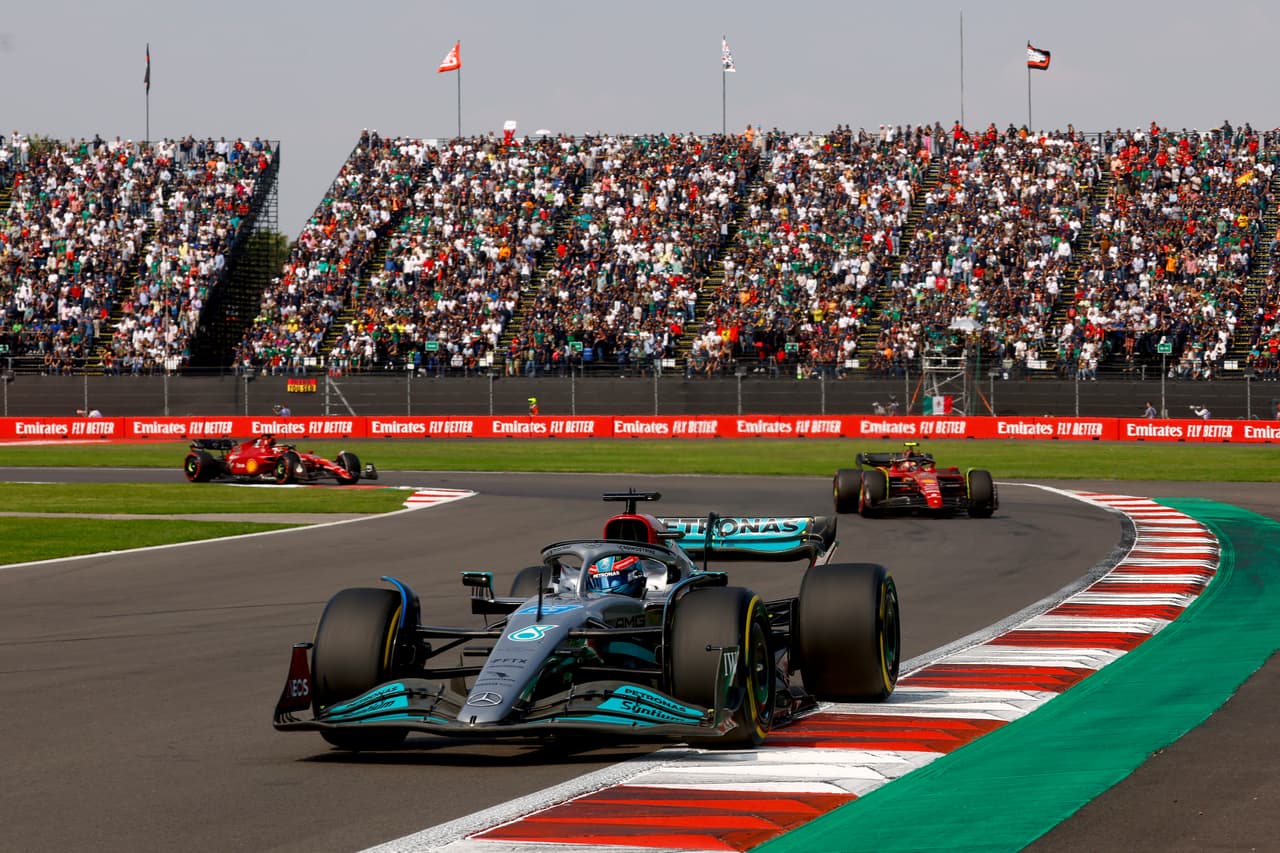 MEXICO CITY, MEXICO - OCTOBER 30: George Russell of Great Britain driving the (63) Mercedes AMG Petronas F1 Team W13 leads Carlos Sainz of Spain driving (55) the Ferrari F1-75 during the F1 Grand Prix of Mexico at Autodromo Hermanos Rodriguez on October 30, 2022 in Mexico City, Mexico. (Photo by Chris Graythen/Getty Images)