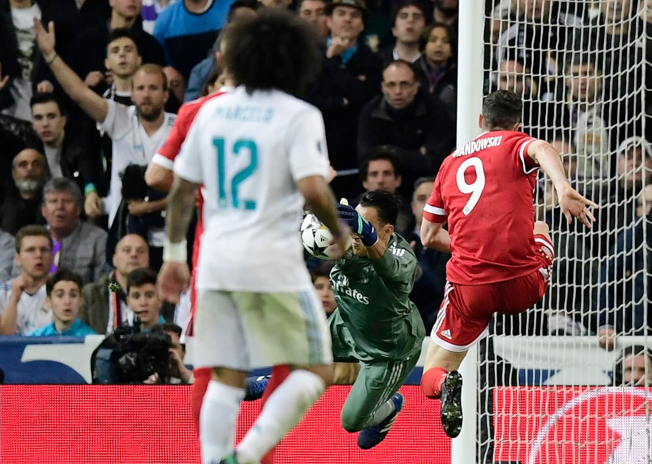 Real Madrid's Costa Rican goalkeeper Keylor Navas saves a ball in front of Bayern Munich's Polish forward Robert Lewandowski during the UEFA Champions League semi-final second leg football match between Real Madrid and Bayern Munich at the Santiago Bernabeu Stadium in Madrid on May 1, 2018. (Photo by JAVIER SORIANO / AFP) (Photo credit should read JAVIER SORIANO/AFP/Getty Images)