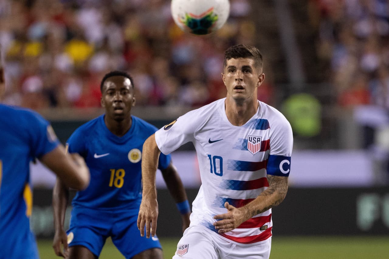 Jun 30, 2019; Philadelphia, PA, USA; United States midfielder Christian Pulisic (10) chases a high ball against Curacao during the first half of quarterfinal play in the CONCACAF Gold Cup soccer tournament at Lincoln Financial Field. Mandatory Credit: Bill Streicher-USA TODAY Sports