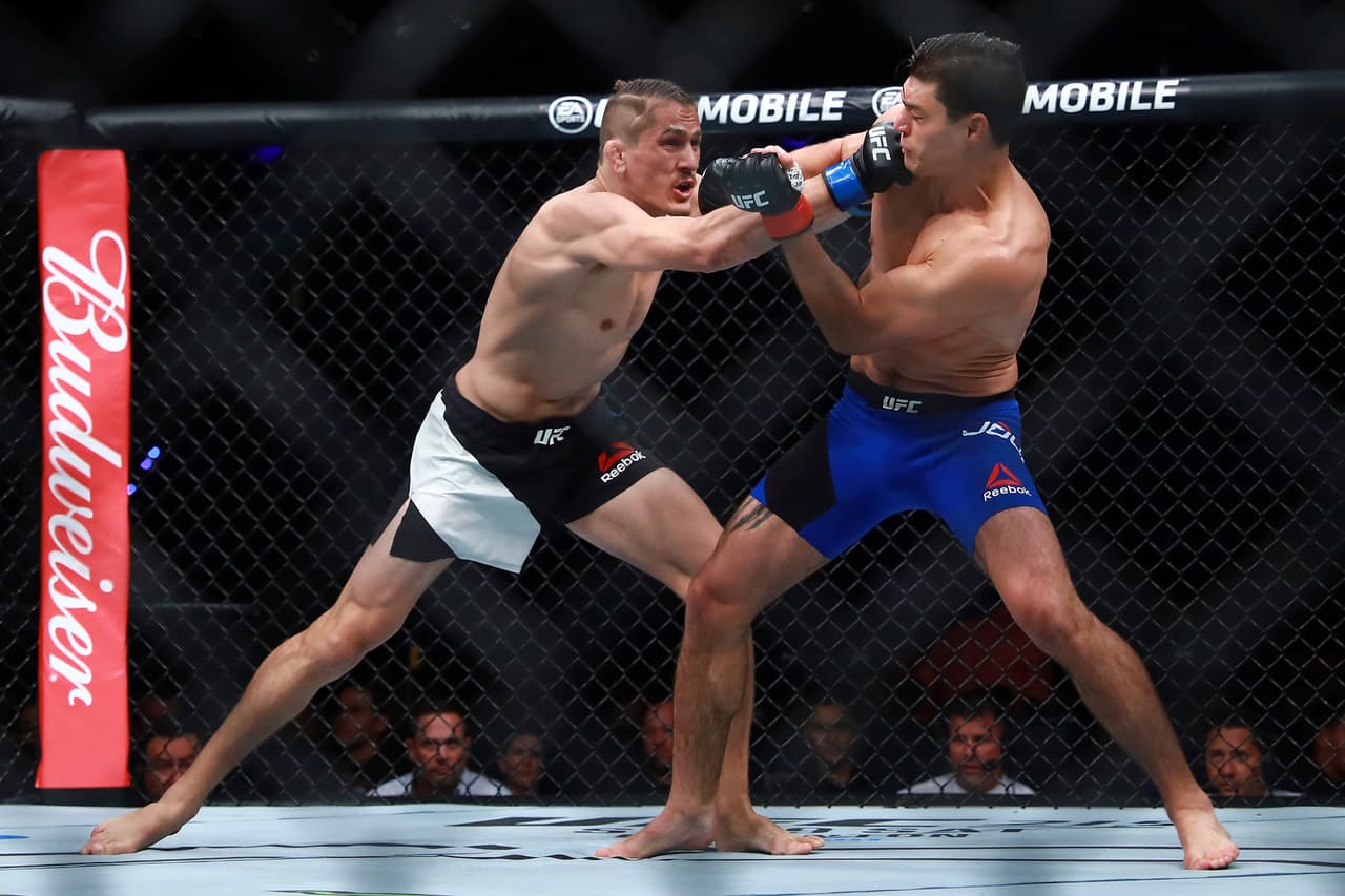 MEXICO CITY, MEXICO - AUGUST 05: Niko Price of United States punches Alan Jouban of United States during the UFC Fight Night Mexico City at Arena Ciudad de Mexico on August 05, 2017 in Mexico City, Mexico. (Photo by Hector Vivas/Getty Images)