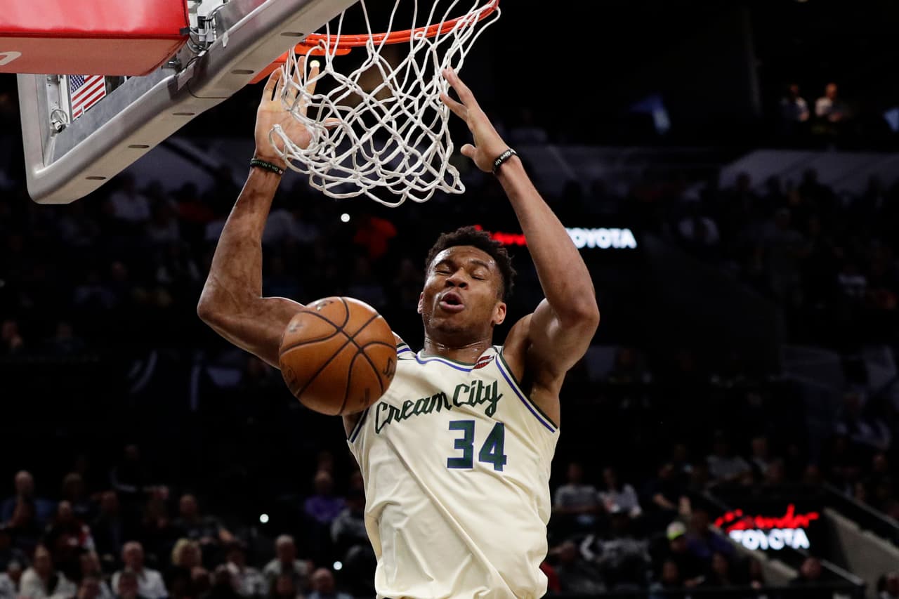 Milwaukee Bucks forward Giannis Antetokounmpo (34) scores against the San Antonio Spurs during the first half of an NBA basketball game in San Antonio, Monday, Jan. 6, 2020. (AP Photo/Eric Gay)
