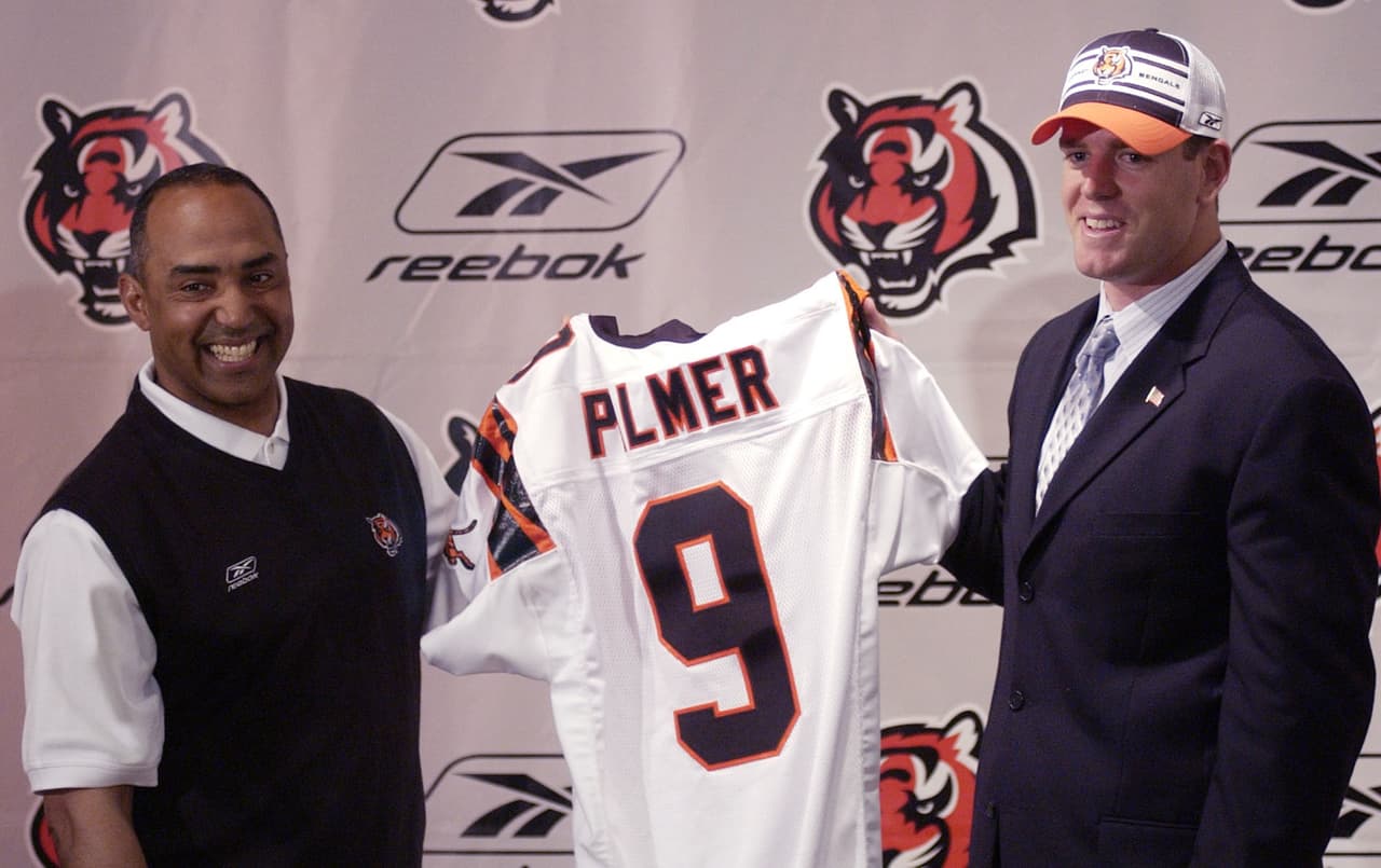 2003 — CARSON PALMER
<b>Cincinnati Bengals</b> | QB Southern Cal
<br>El mariscal de campo Carson Palmer y el entrenador de Cincinnati, Marvin Lewis, sostienen un jersey de los Bengals durante una conferencia de prensa en el Estadio Paul Brown en Cincinnati, el jueves 24 de abril de 2003. Palmer, elegido #1 global por los Bengals en el NFL Draft, firmó un contrato con el equipo. (Foto AP / Tom Uhlman)