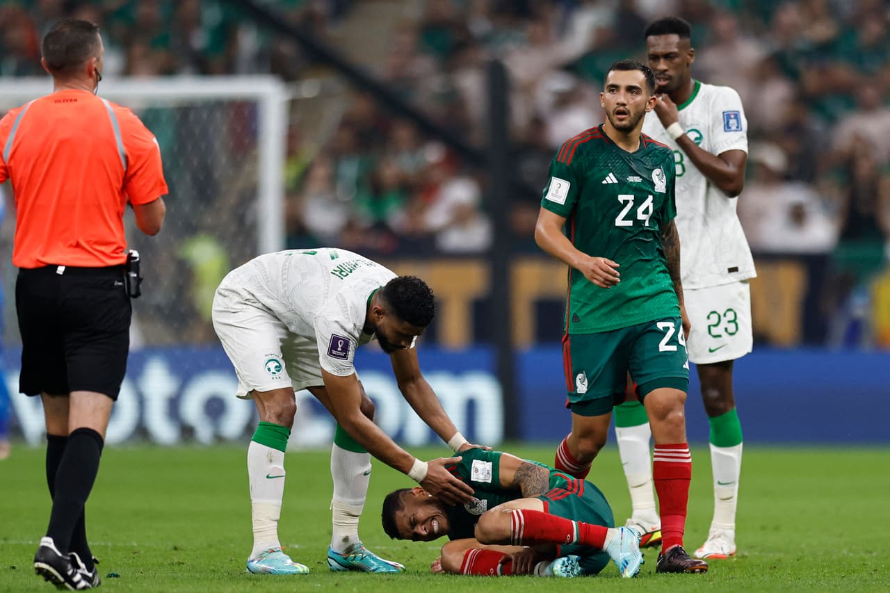 Saudi Arabia's defender #04 Abdulelah Al-Amri checks on Mexico's midfielder #17 Orbelin Pineda during the Qatar 2022 World Cup Group C football match between Saudi Arabia and Mexico at the Lusail Stadium in Lusail, north of Doha on November 30, 2022. (Photo by Khaled DESOUKI / AFP) (Photo by KHALED DESOUKI/AFP via Getty Images)