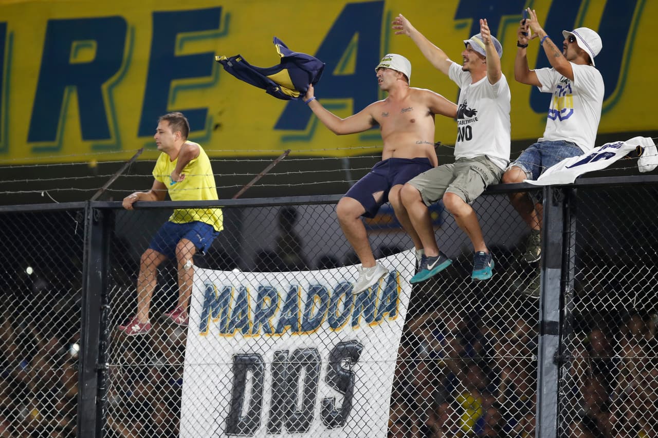 Una manta con la leyenda 'Maradona Dios' en el alambrado de La Doce, la barra de Boca.