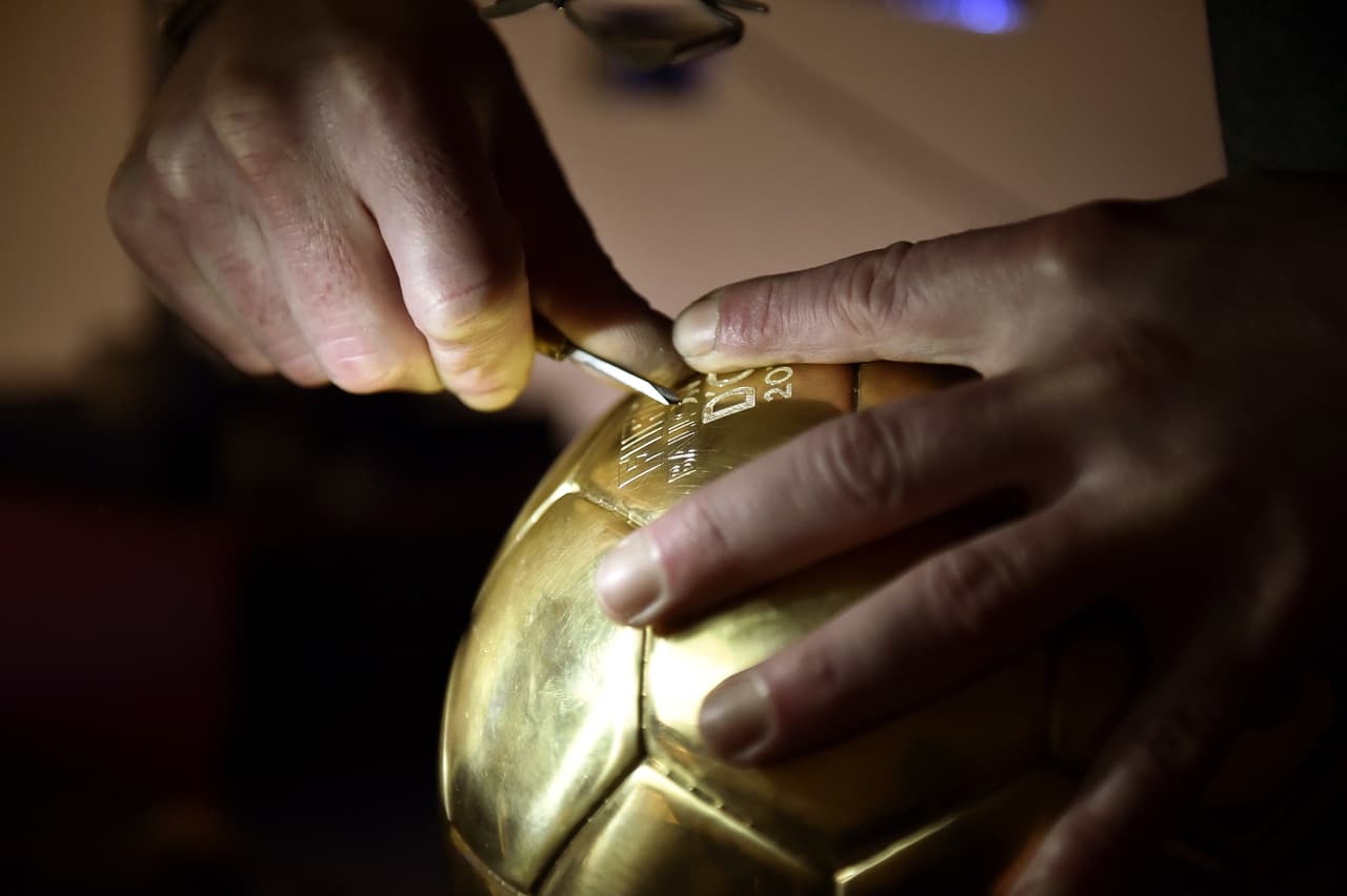 An engraver works on the "Ballon D'or" in Paris on December 2 2014, at the French jewelry house Mellerio. Neuer, Messi, Ronaldo were chosen as top three candidates for FIFA Ballon d'Or with the winner due to be announced on January 12, 2014. AFP PHOTO / FRANCK FIFE (Photo credit should read FRANCK FIFE/AFP/Getty Images)