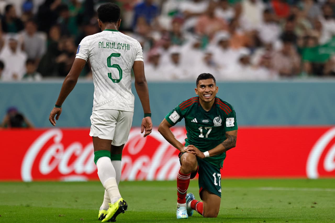 Mexico's midfielder #17 Orbelin Pineda (R) looks at Saudi Arabia's defender #05 Ali Al-Bulaihi (L) during the Qatar 2022 World Cup Group C football match between Saudi Arabia and Mexico at the Lusail Stadium in Lusail, north of Doha on November 30, 2022. (Photo by Khaled DESOUKI / AFP) (Photo by KHALED DESOUKI/AFP via Getty Images)