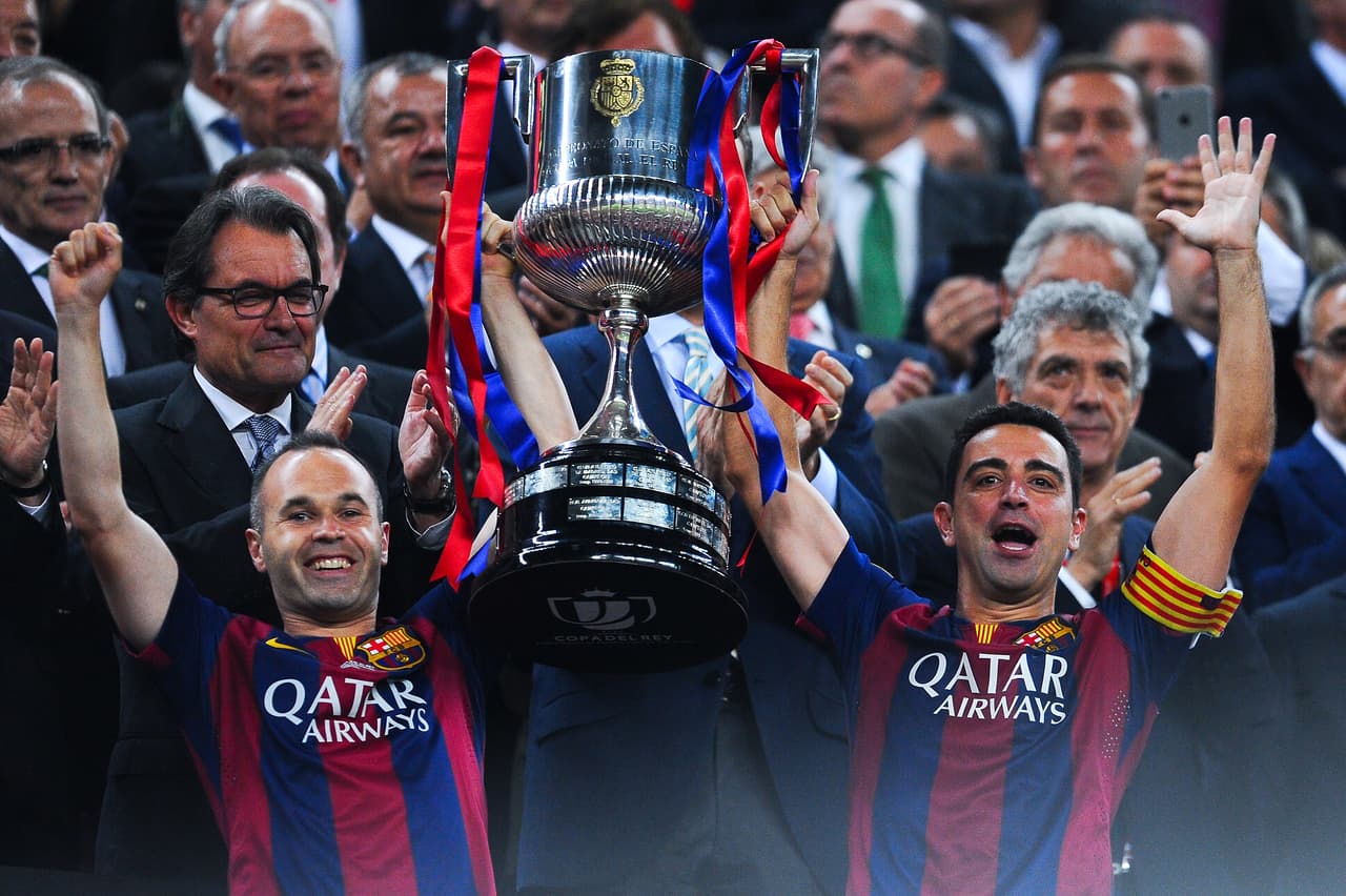 BARCELONA, SPAIN - MAY 30: FC Barcelona players Andres Iniesta (L) and Xavi Hernandez of FC Barcelona celebrate with the trophy after winning the Copa del Rey Final match between FC Barcelona and Athletic Club at Camp Nou on May 30, 2015 in Barcelona, Spain. (Photo by David Ramos/Getty Images)