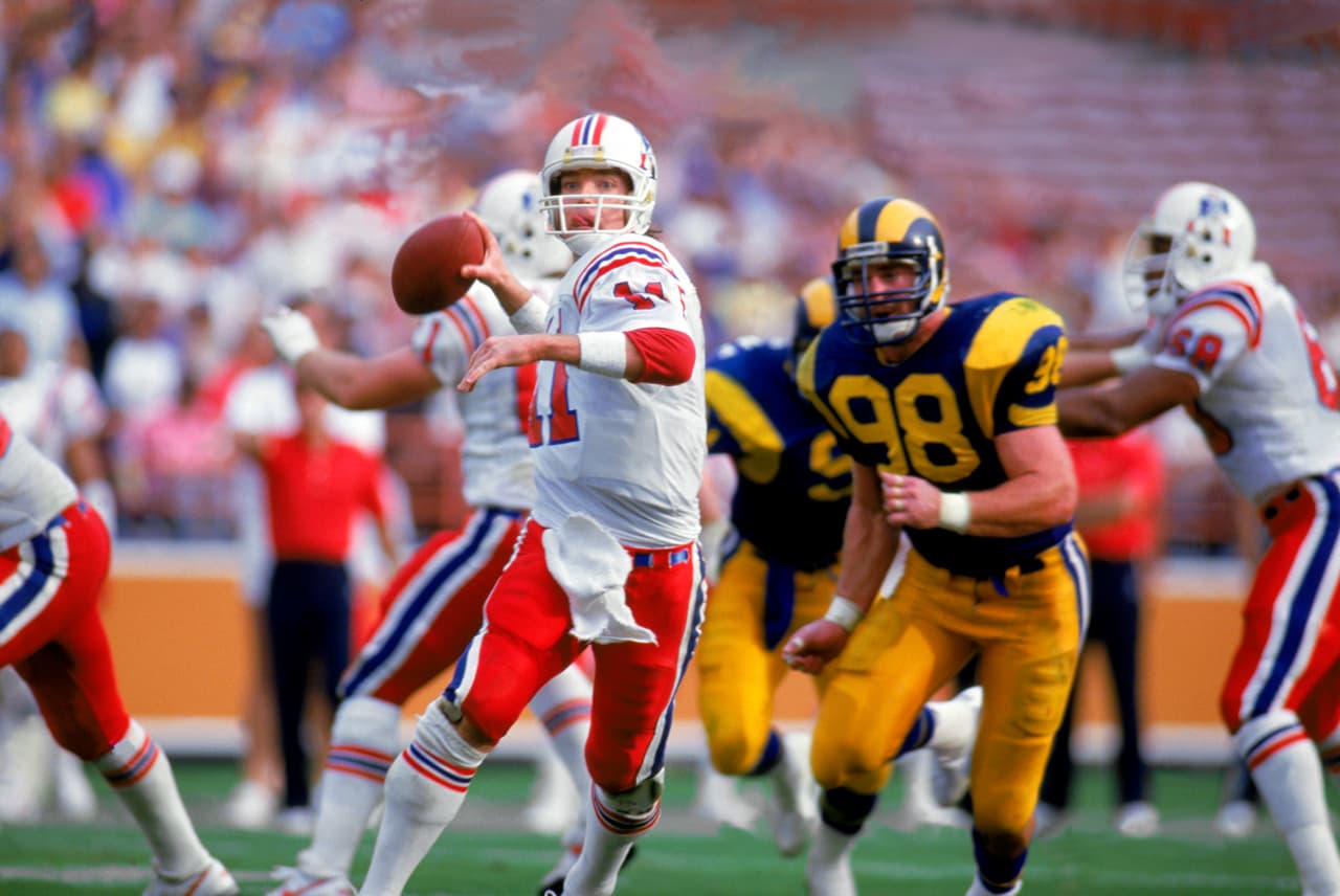 LOS ANGELES - 1986: Quarterback Tony Eason #11 of the New England Patriots rolls out under pressure during a 1986 NFL game against the Los Angeles Rams at LA Memorial Coliseum in Los Angeles, California. The Pats defeated the Rams 30-28. (Photo by Tony Duffy/Getty Images)