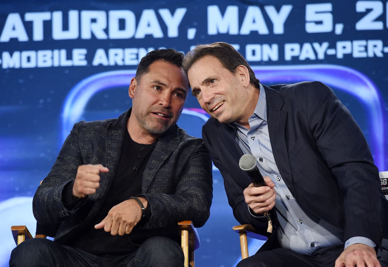 LOS ANGELES, CA - FEBRUARY 27: Oscar De La Hoya (L) promoter of Canelo Alvarez, speaks with Tom Loeffler, promoter of Gennady Golovkin during a news conference at Microsoft Theater at L.A. Live to announce the rematch between their boxers on February 27, 2018 in Los Angeles, California. (Photo by Kevork Djansezian/Getty Images)