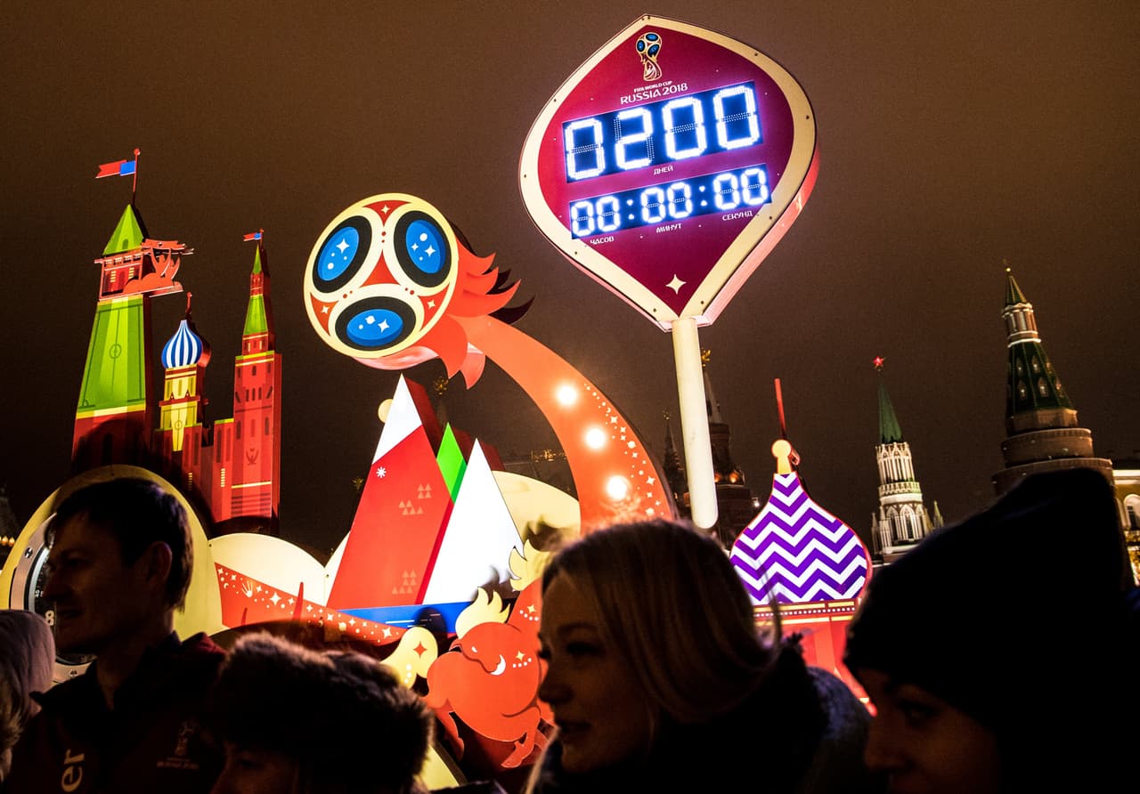 People stand in front of the digital FIFA World Cup 2018 countdown clock which shows exactly 200 days before the beginning of the 2018 World Cup football tournament on November 26, 2017, in front of the Red Square and the Kremlin in Moscow. / AFP PHOTO / Yuri KADOBNOV (Photo credit should read YURI KADOBNOV/AFP/Getty Images)
